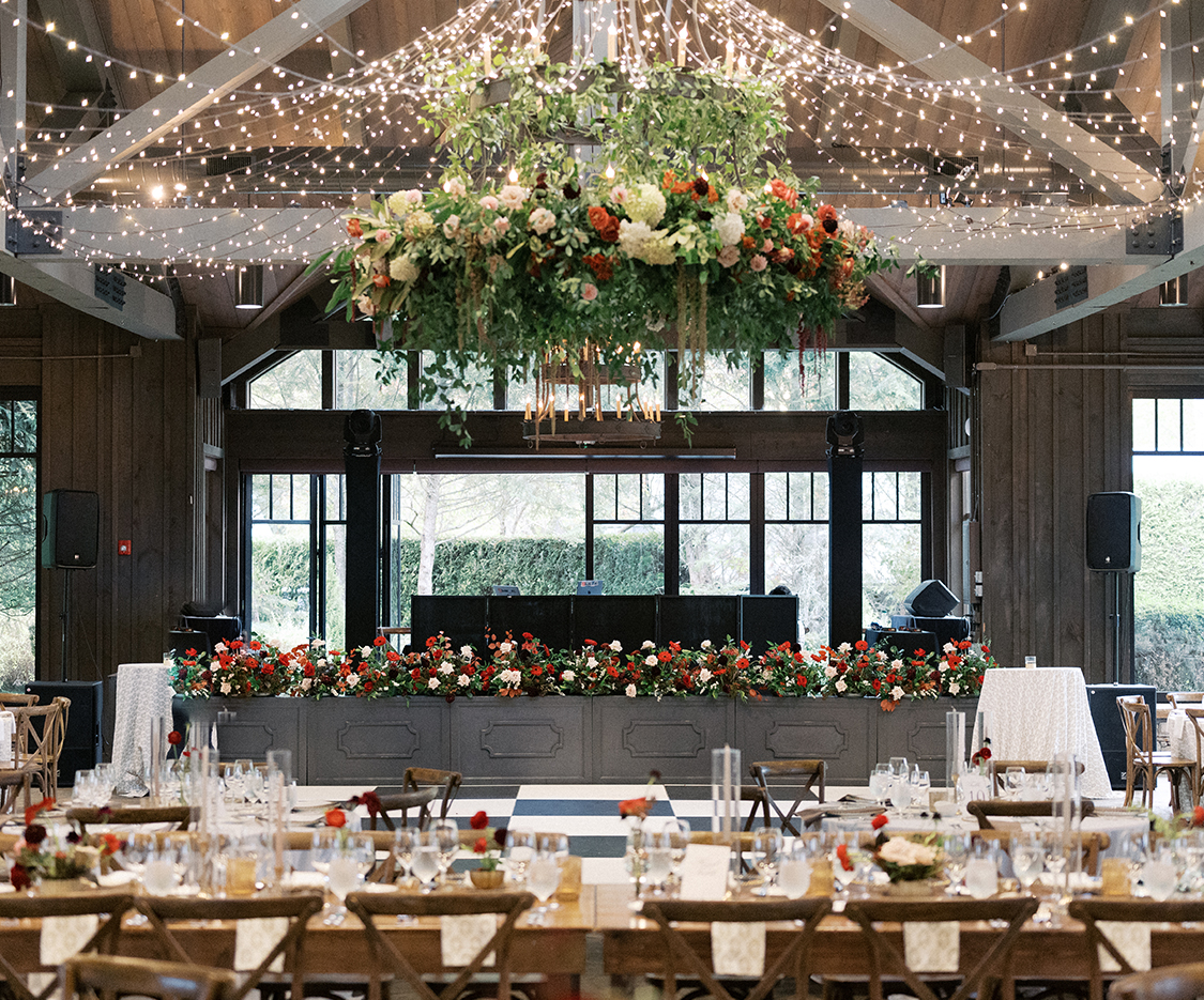 a room with tables and chairs and a chandelier