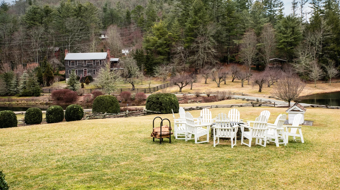 a group of white chairs in a grassy field