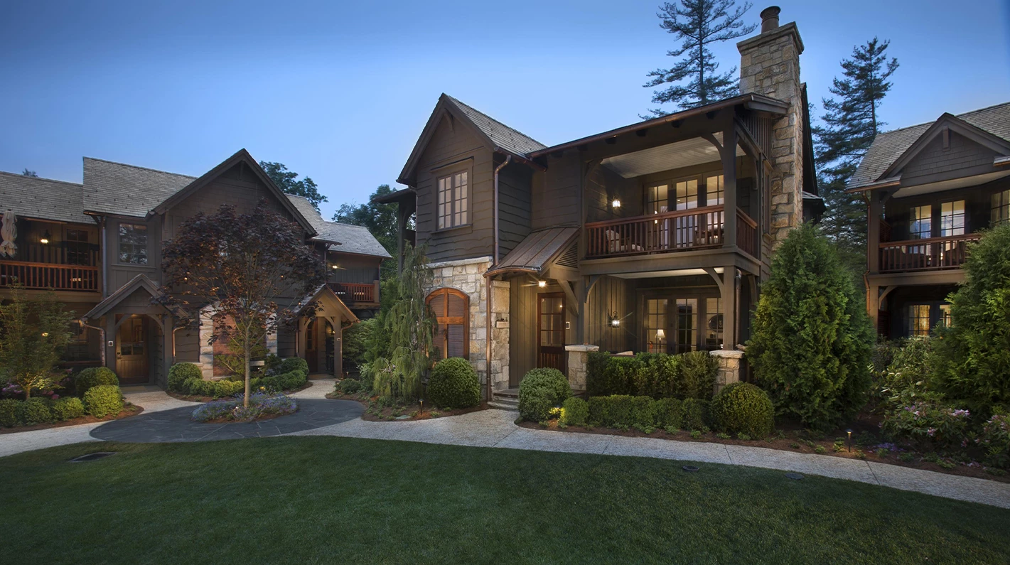 a house with a stone and stone wall and a stone walkway