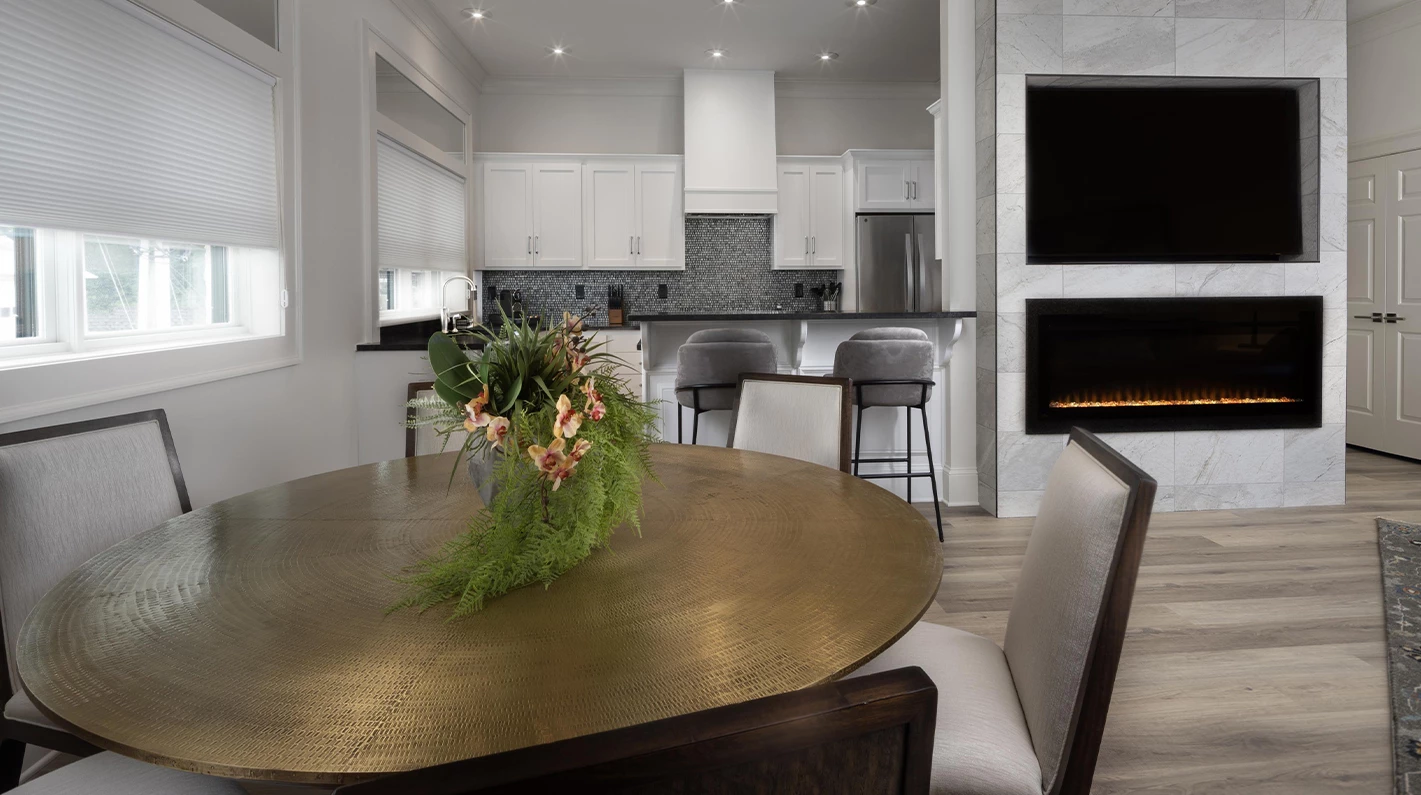 a dining room table with chairs and a fireplace