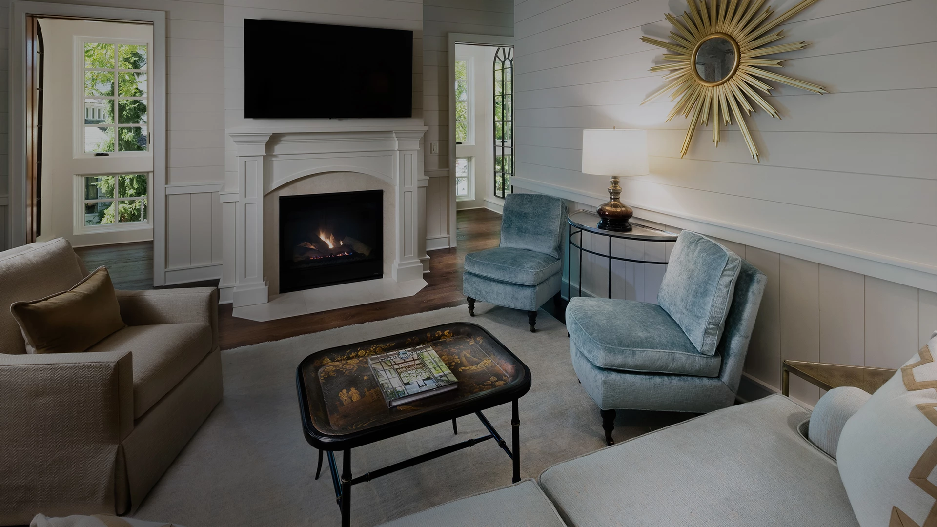a living room with a fireplace and blue chairs