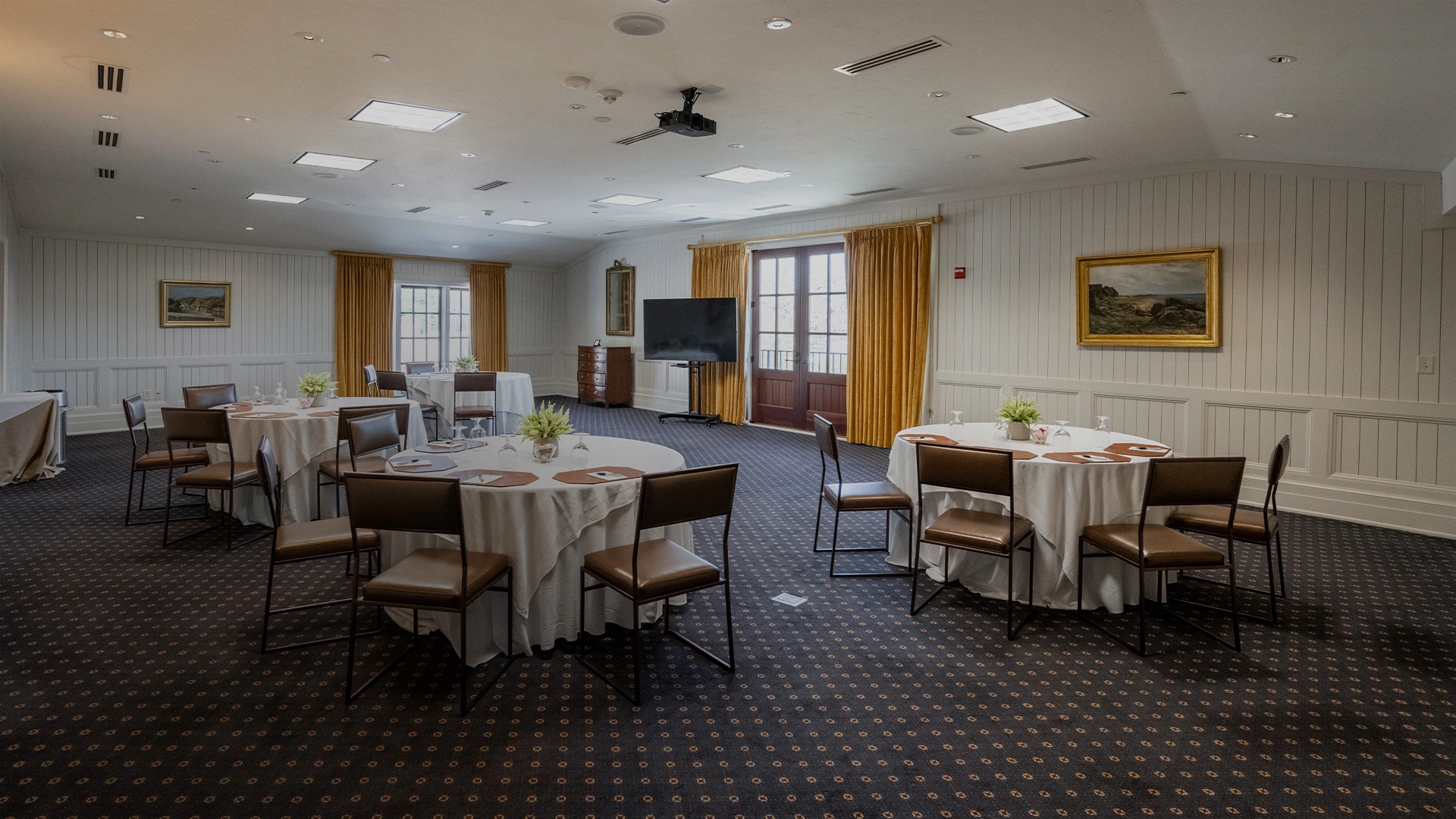a room with round tables and chairs