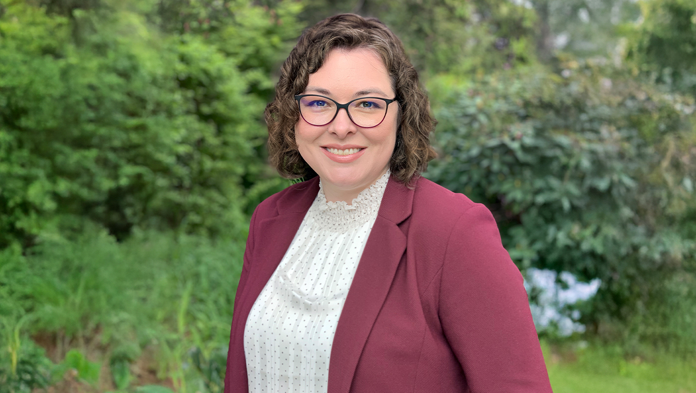 a woman wearing glasses and a red jacket