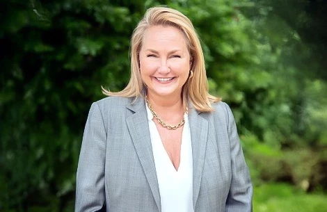 a woman in a suit smiling