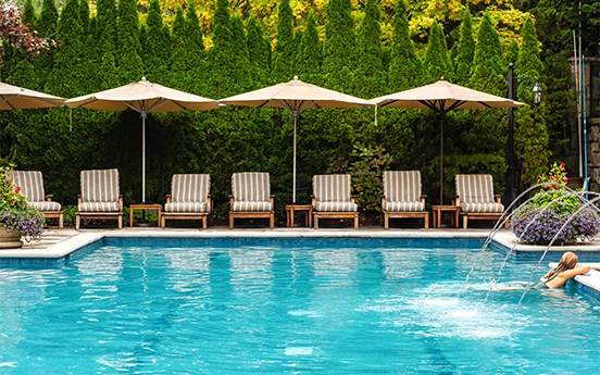a pool with chairs and umbrellas