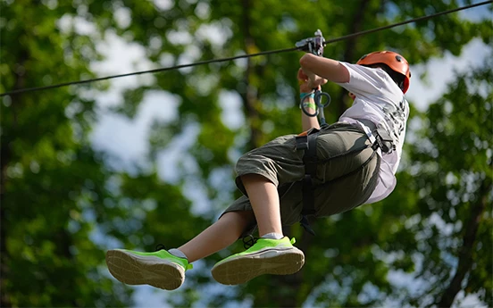 a boy in a zip line
