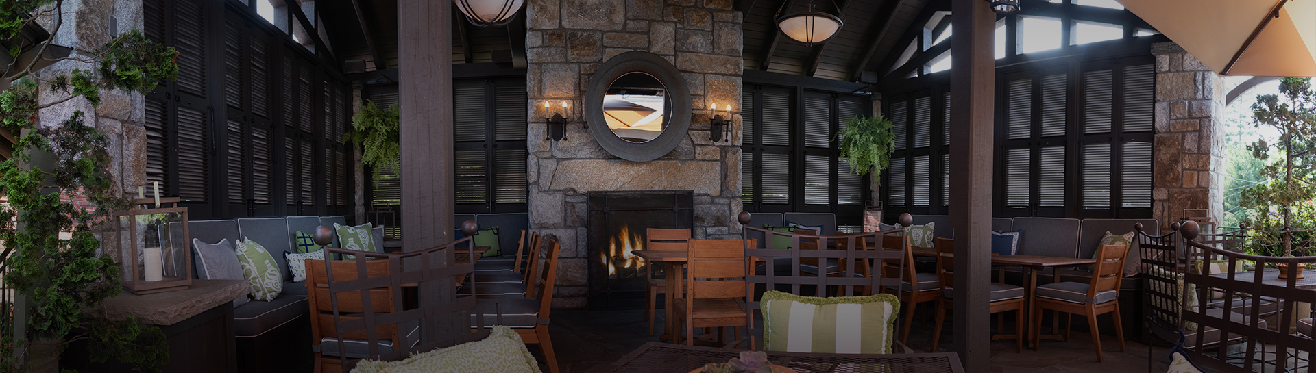a room with a stone fireplace and chairs