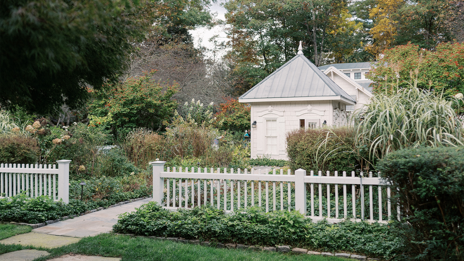 a white fence in front of a house