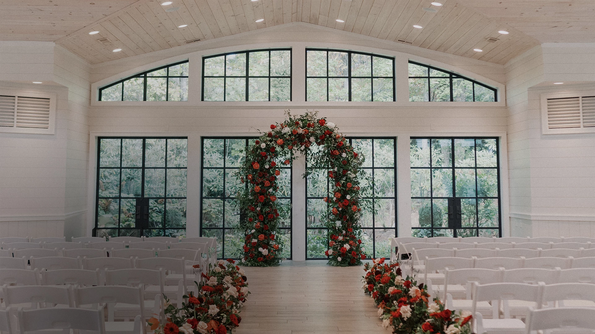 a wedding ceremony with flowers and chairs