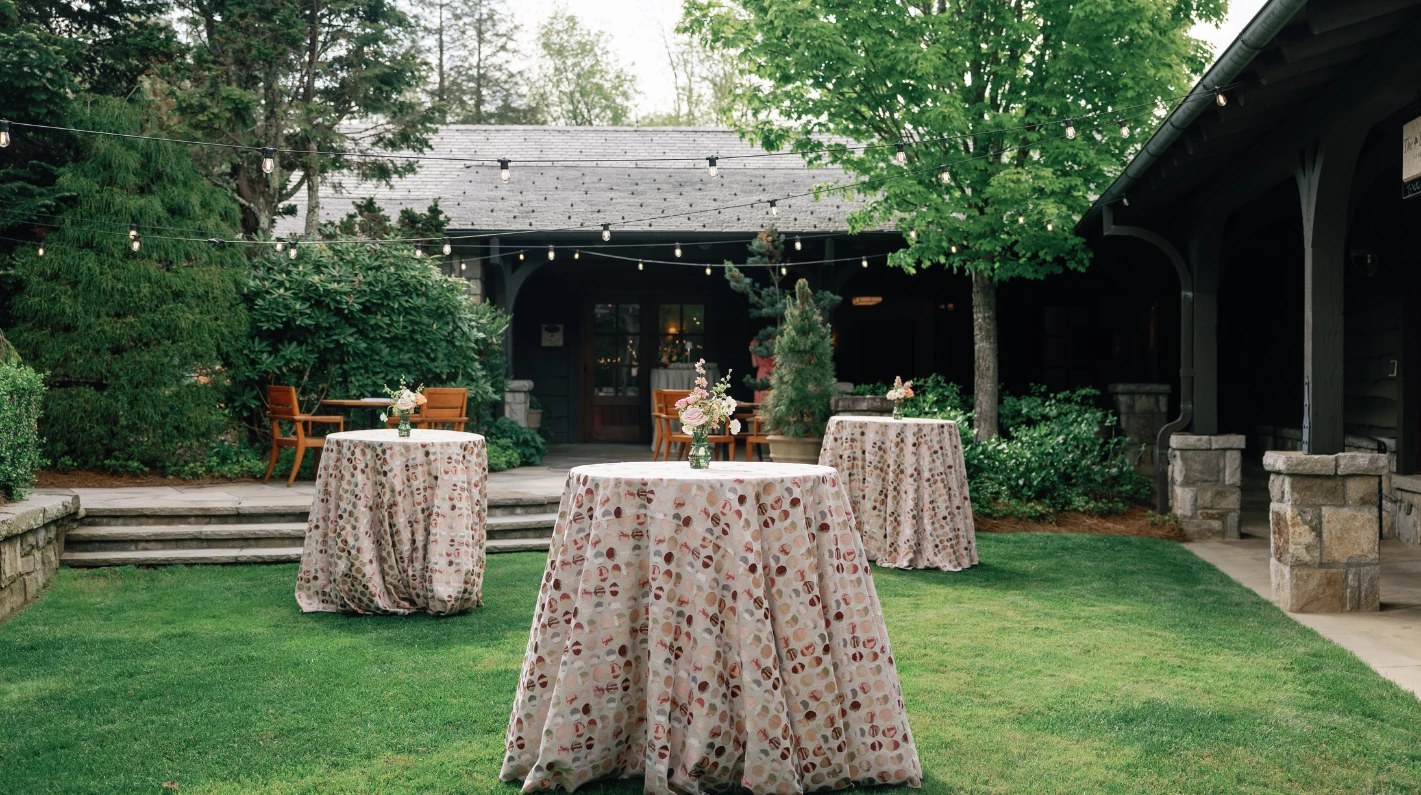 a table covered in cloth with flowers on it