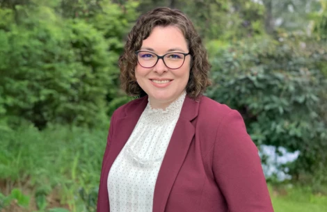 a woman wearing glasses and a red jacket