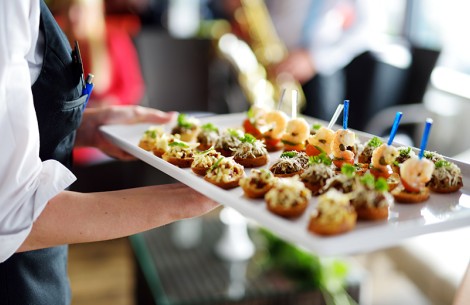 a person holding a tray of food