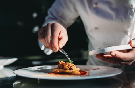 a person holding a plate of food