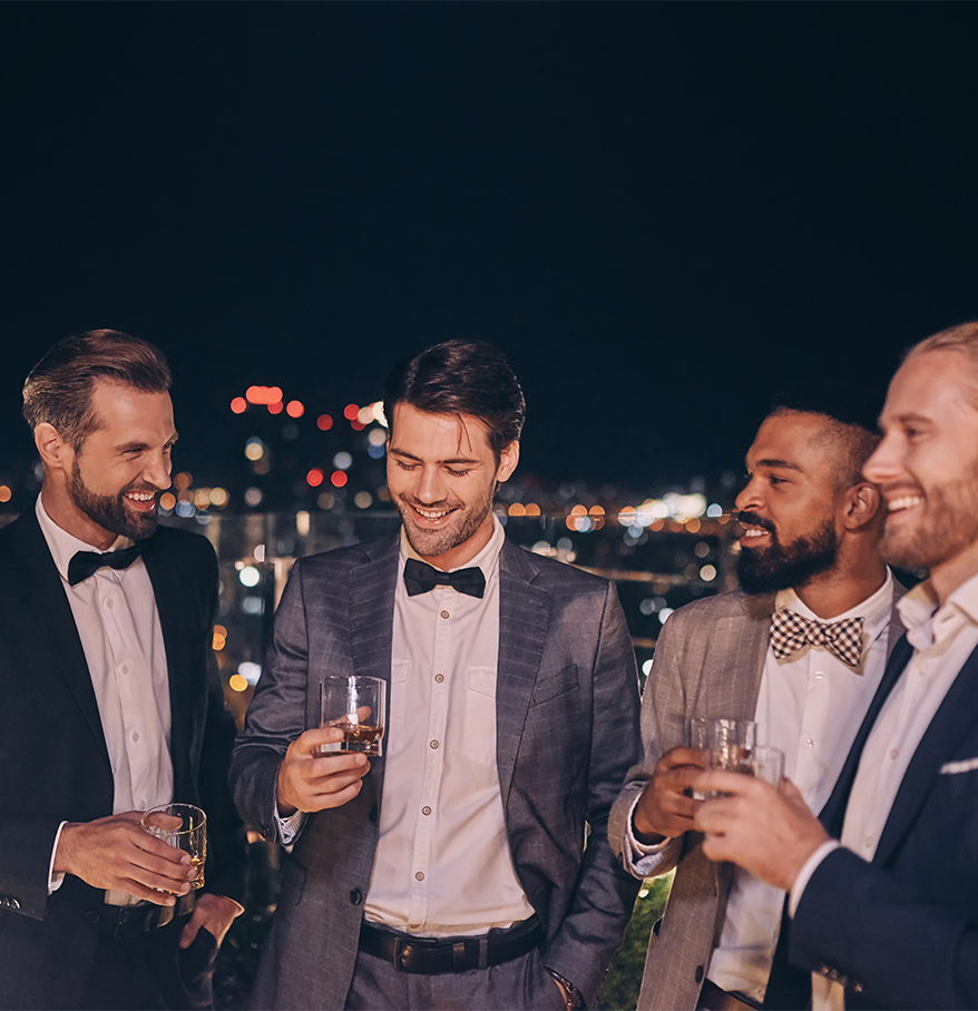 a group of men in suits holding drinks