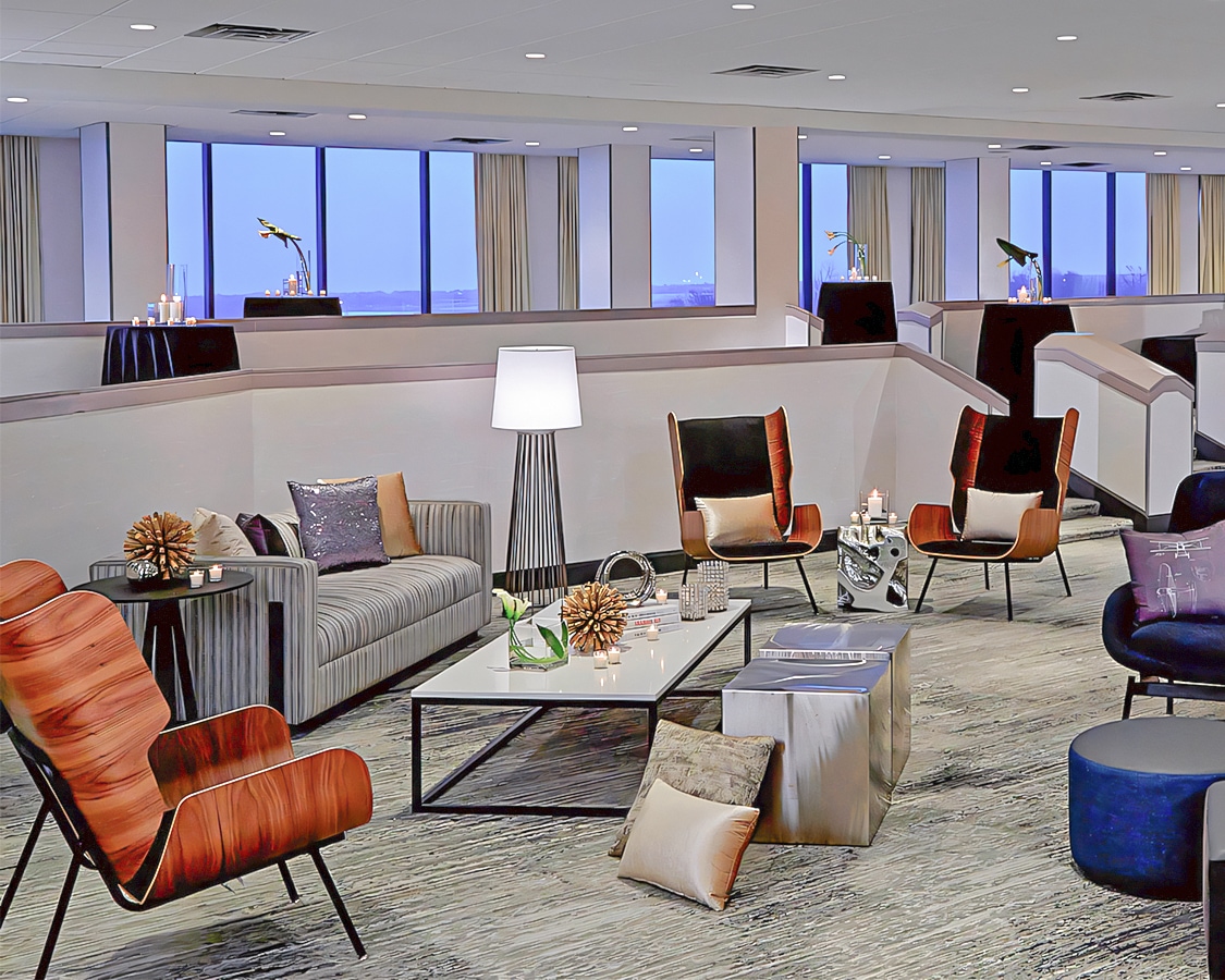 a room with a couch and chairs