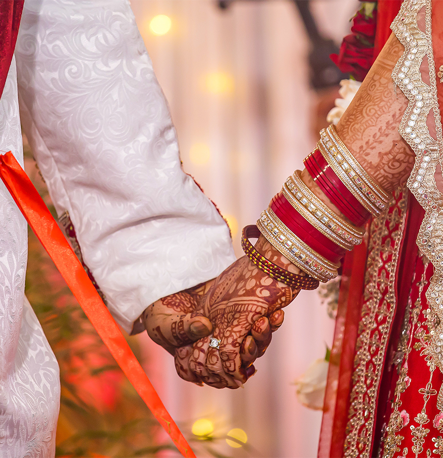 a couple holding hands with bracelets