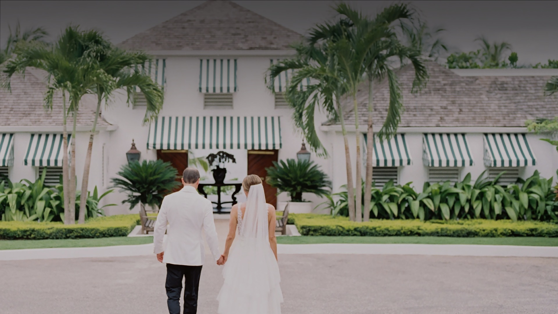 a man and woman walking in front of a building