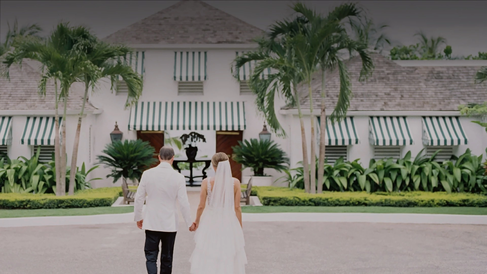 a man and woman walking in front of a building