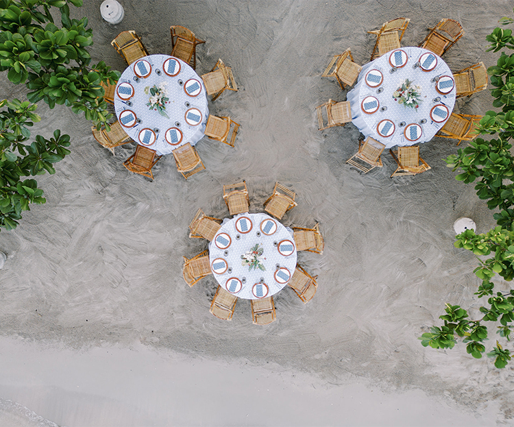 a group of tables and chairs on a beach