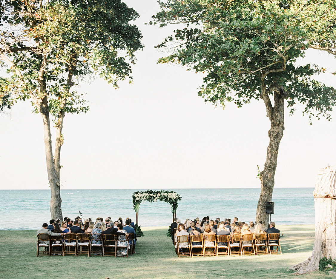 a group of people sitting in chairs under trees