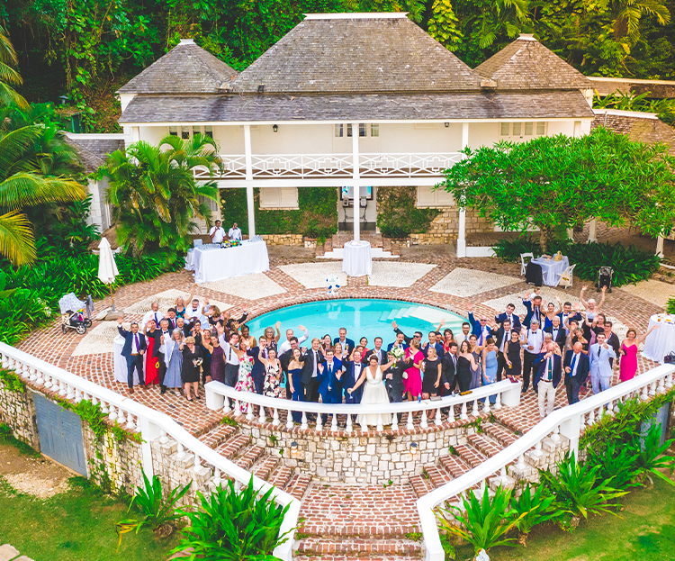 a group of people standing in front of a pool