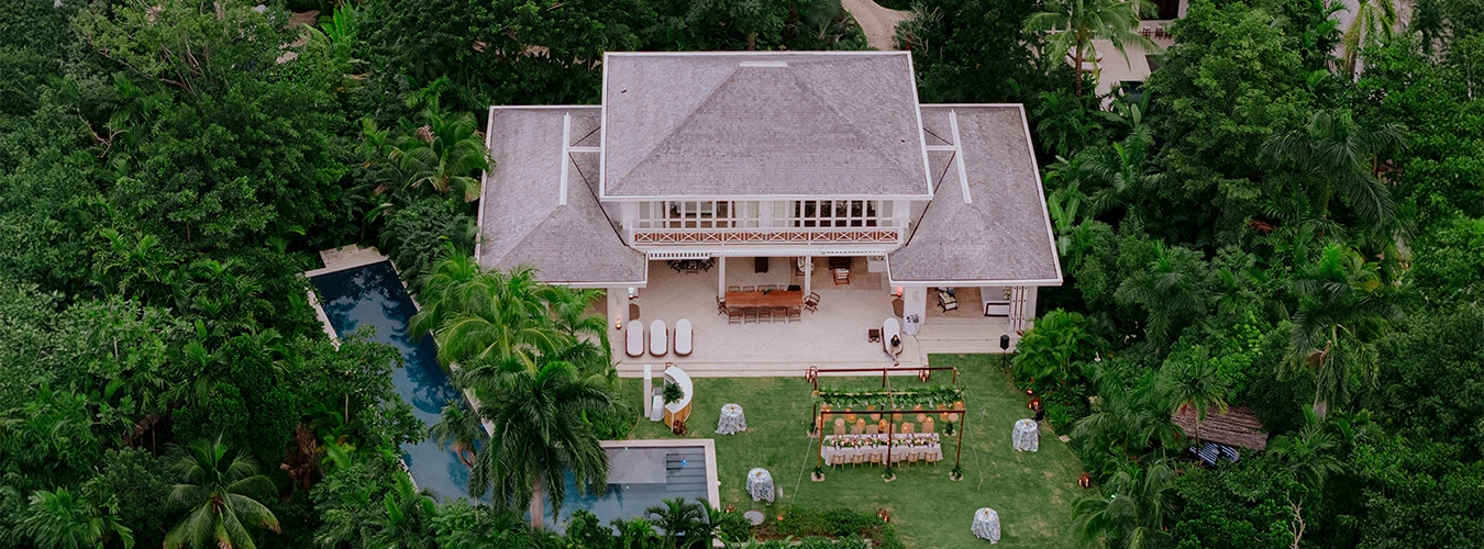 a house with a pool and tables