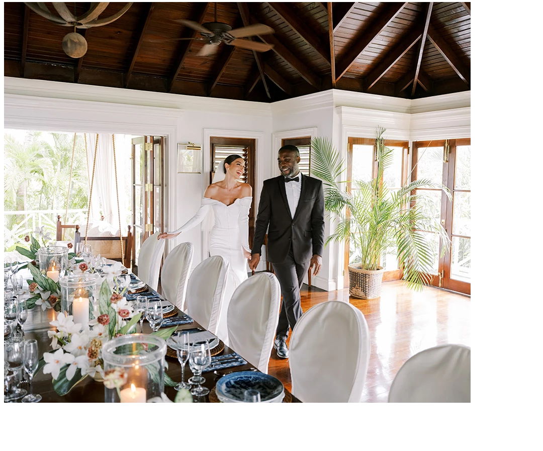 a man and woman in a room with a table with flowers and candles