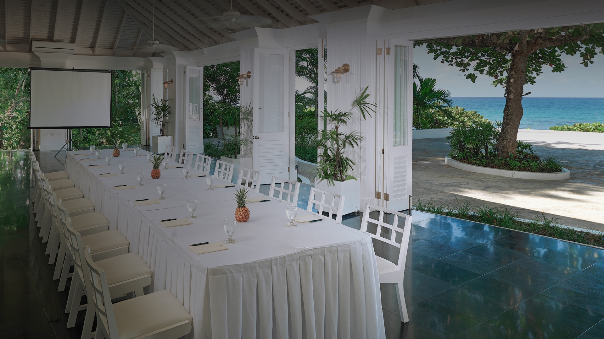 a long table with white tablecloths and chairs