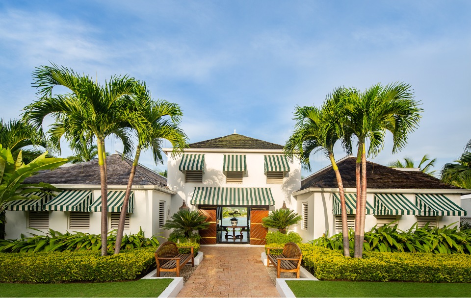 a building with palm trees and a walkway