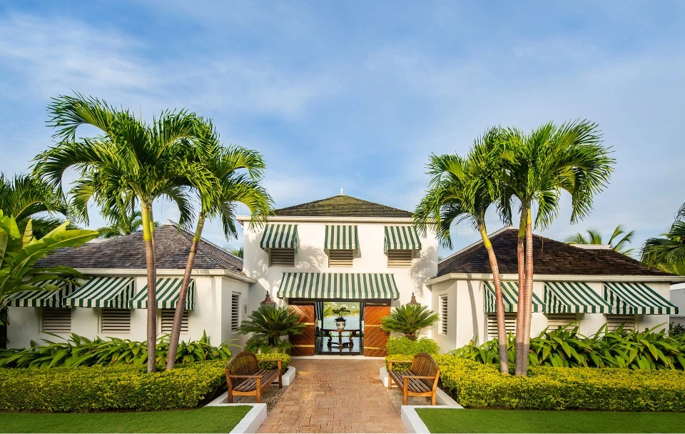 a building with palm trees and a walkway