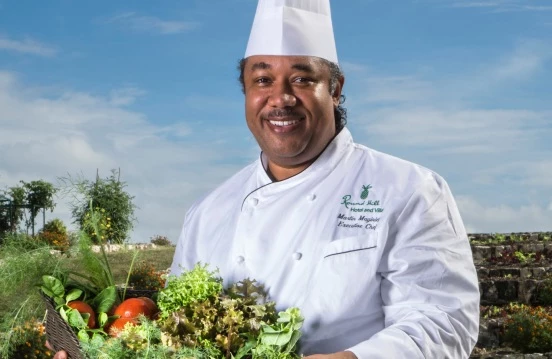 a chef holding a bowl of vegetables
