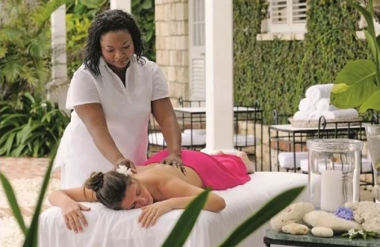 a woman lying on a bed with a woman in her arms