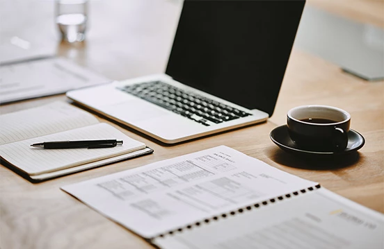 a laptop and coffee on a table