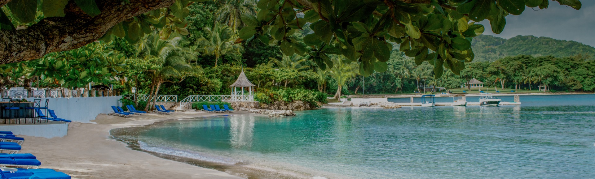 a beach with chairs and a gazebo