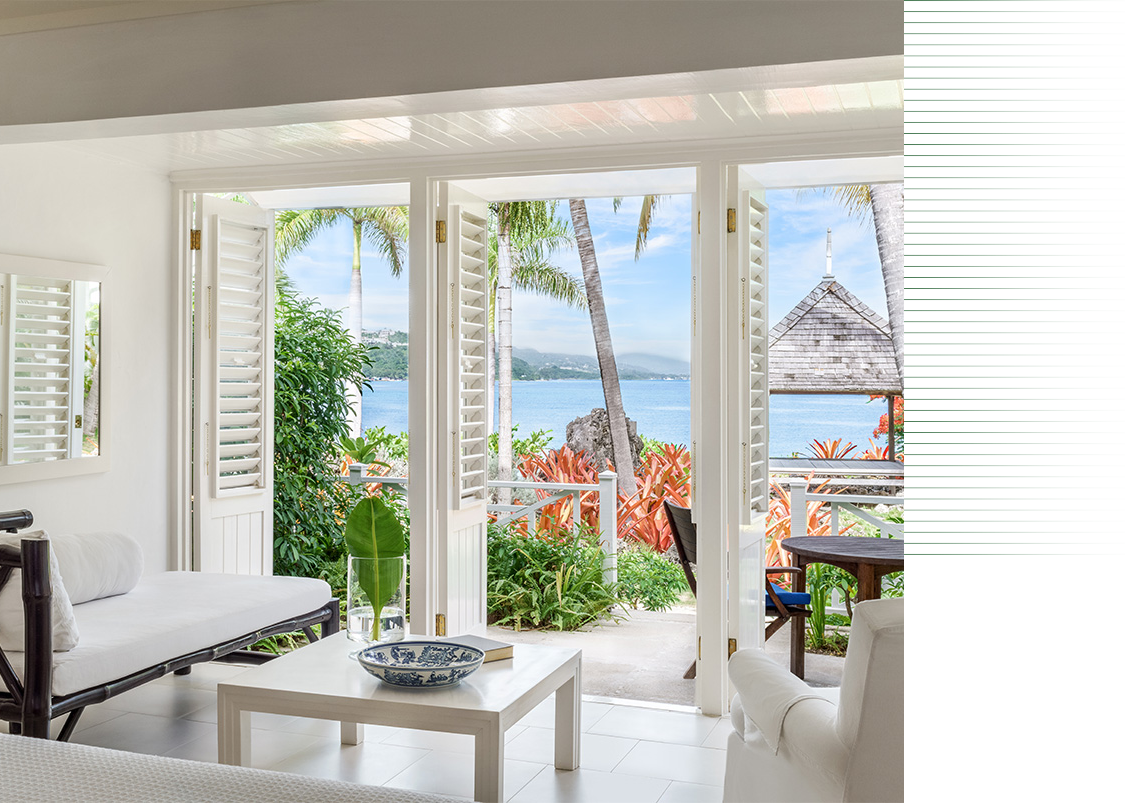 a room with a view of the ocean and a couch