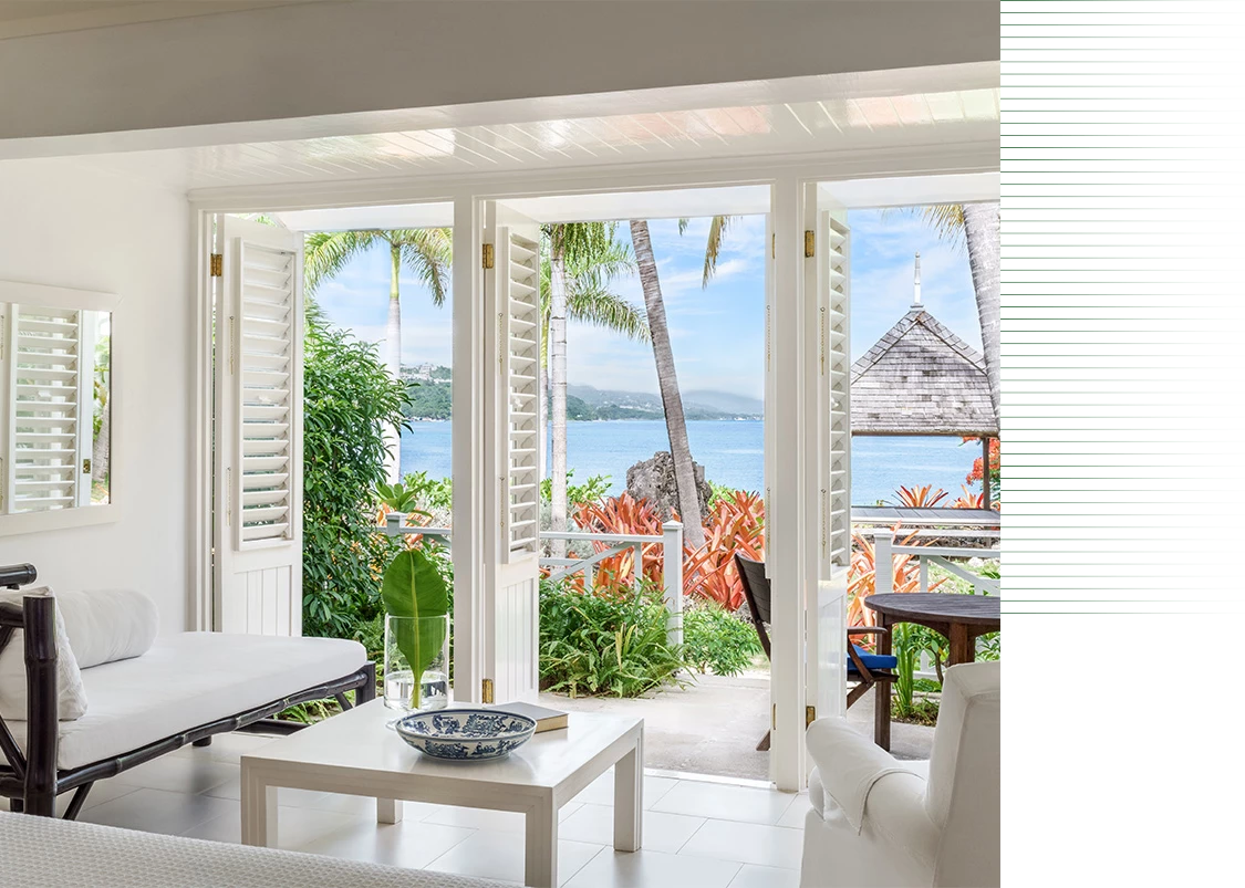 a room with a view of the ocean and a couch