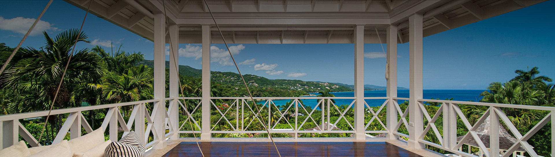 a view of a tropical landscape from a porch