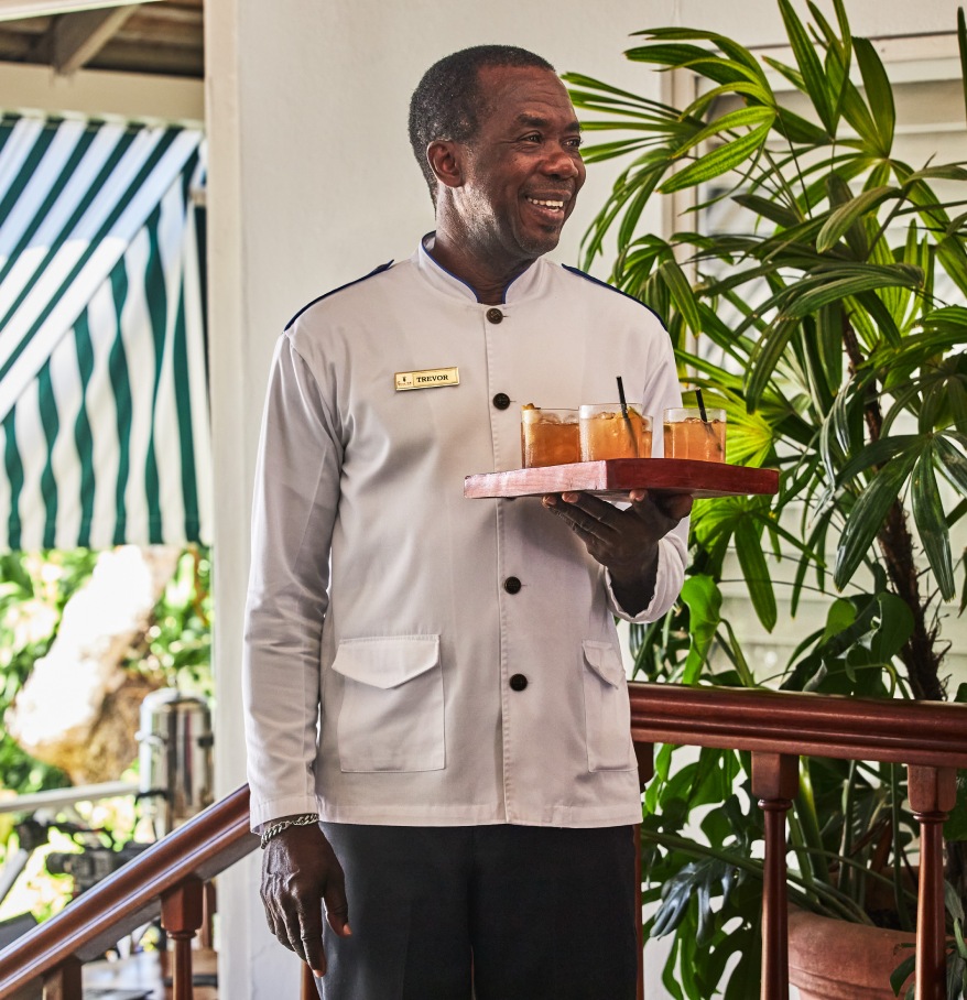a man holding a tray of drinks