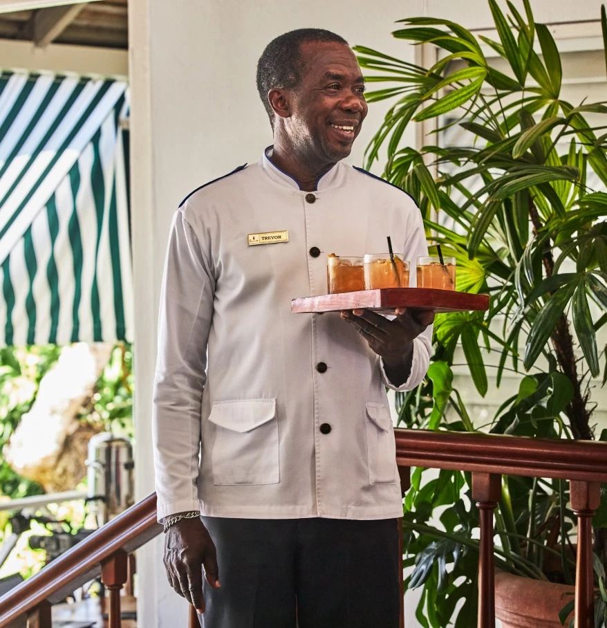 a man holding a tray of drinks