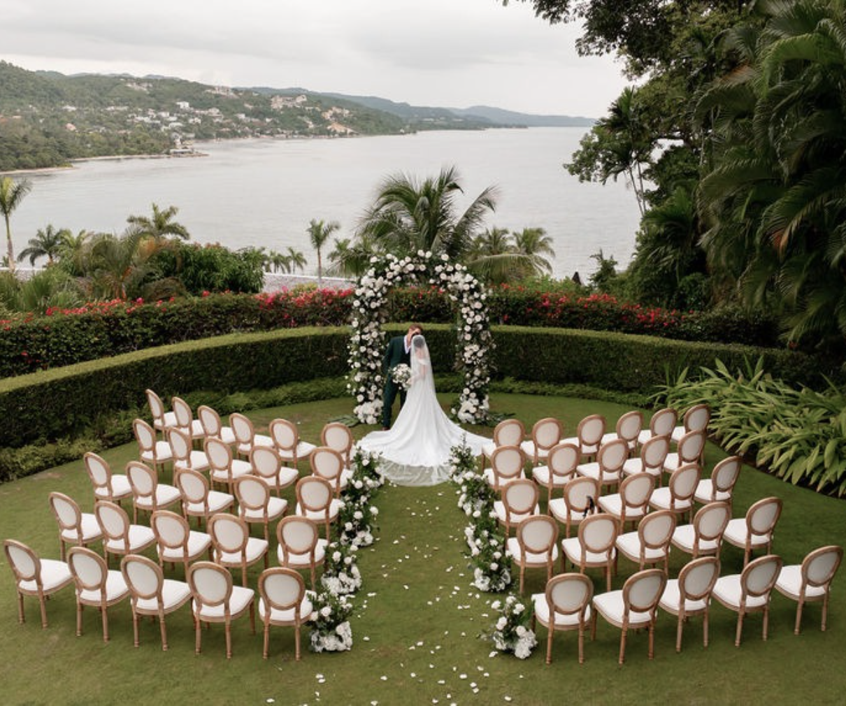 a bride in a wedding dress standing in front of a set of chairs