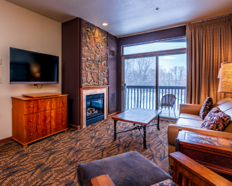 a living room with a television and a fireplace