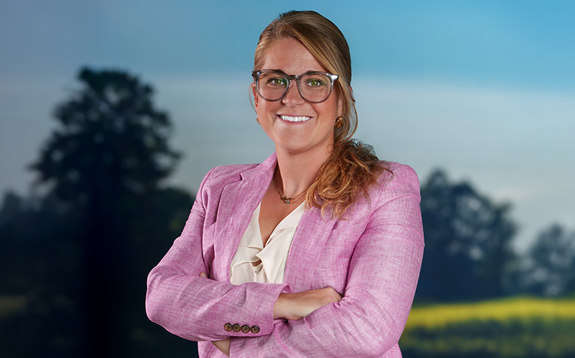 a woman wearing glasses and a pink jacket