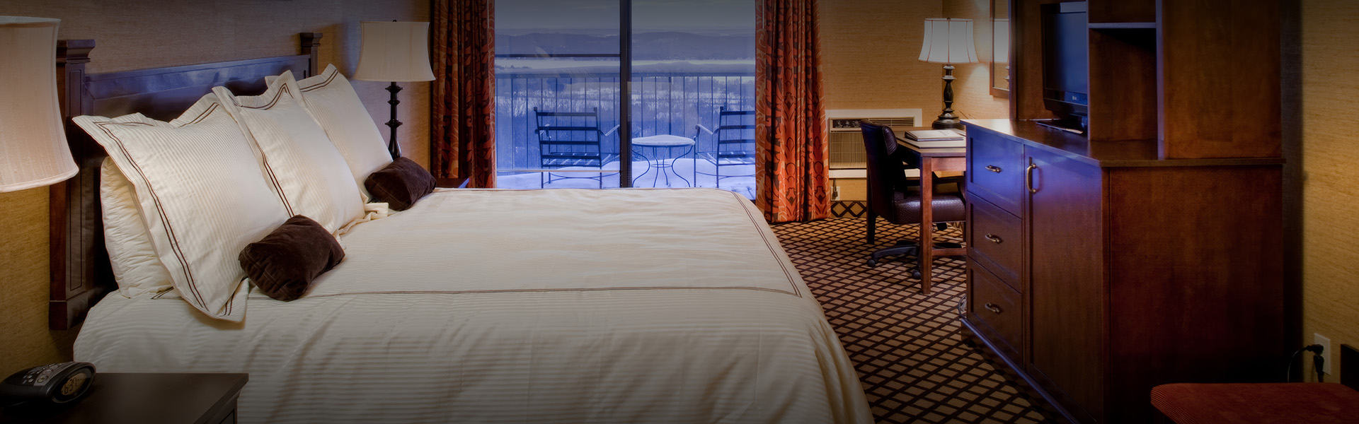 a hotel room with a bed and chairs