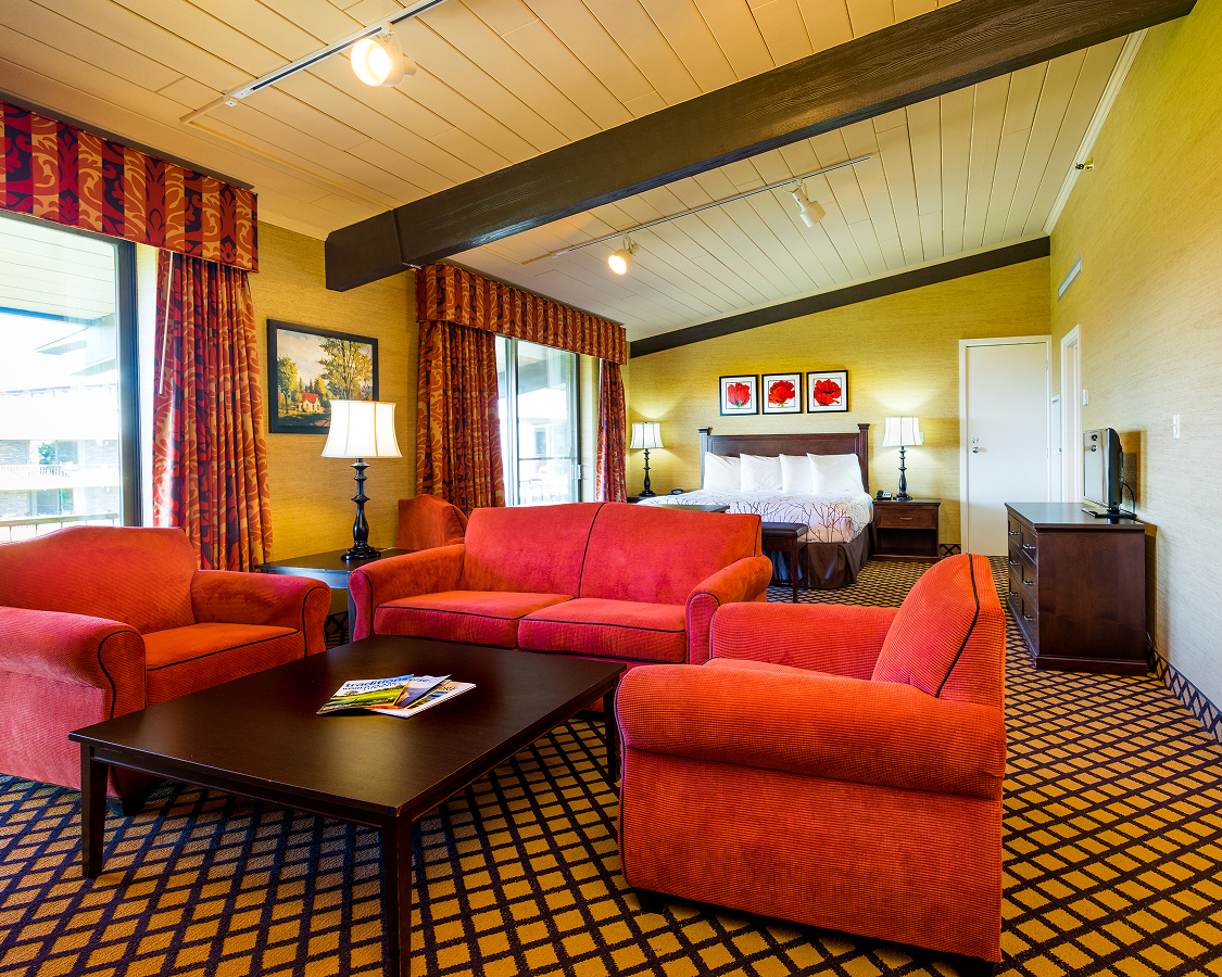 a room with red couches and a bed