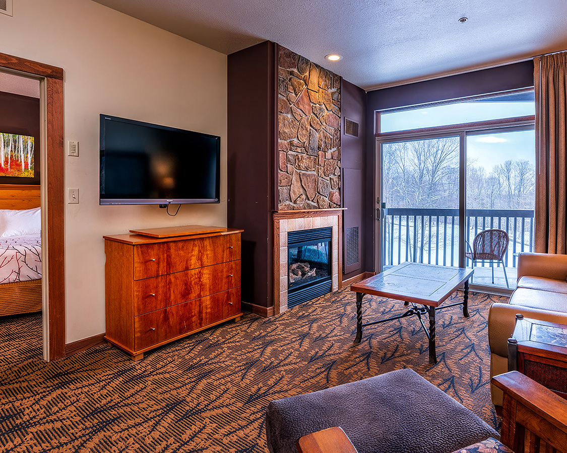a living room with a television and a fireplace
