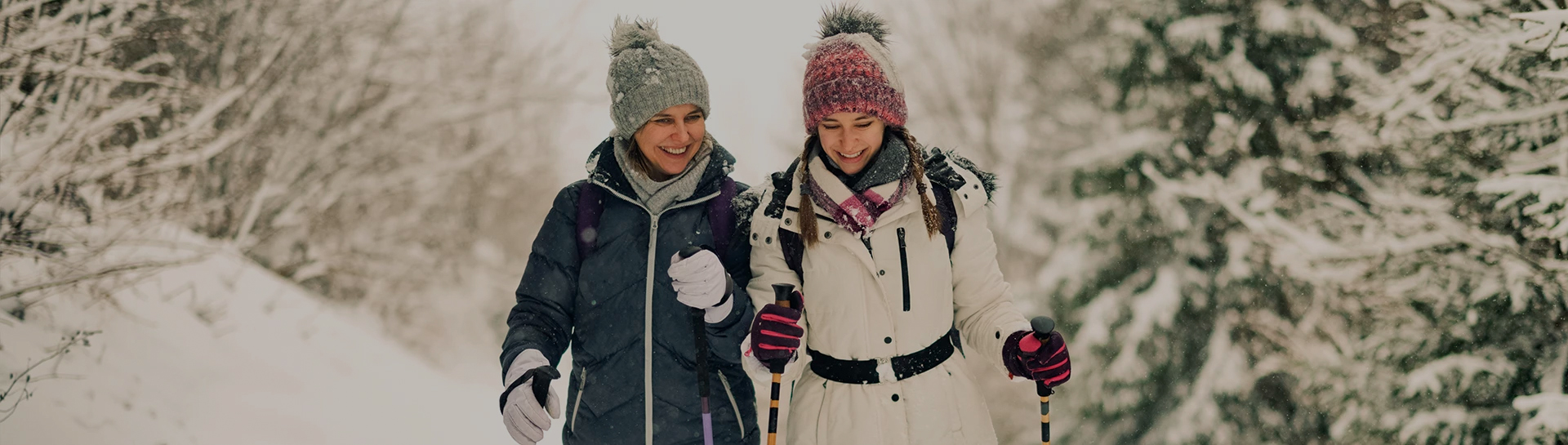 two women in winter clothes smiling