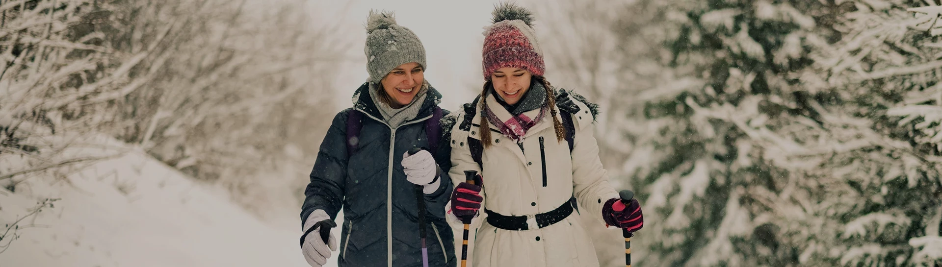 two women in winter clothes smiling
