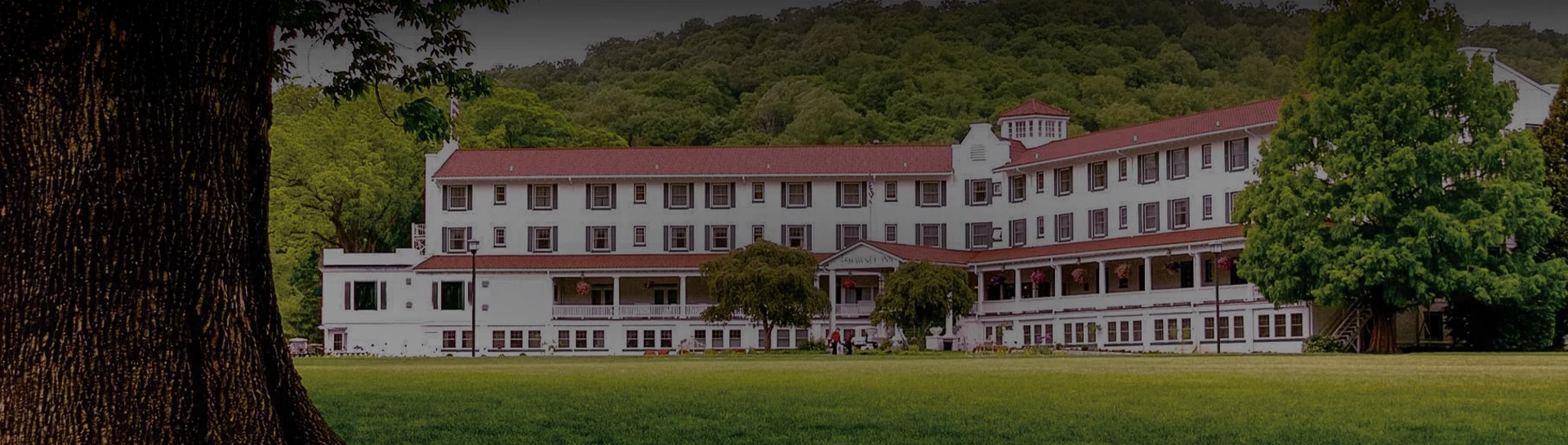 a large white building with a red roof with Rock Ford Plantation in the background