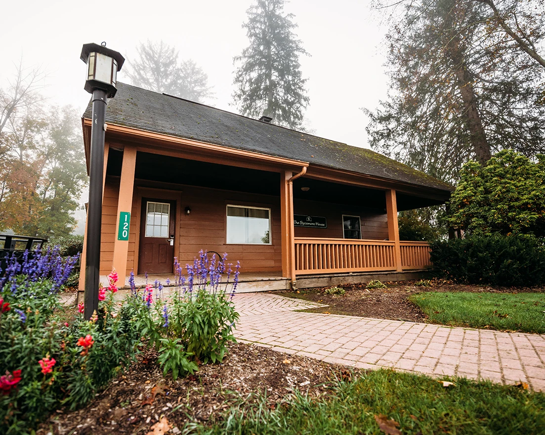 a house with a porch and a brick walkway