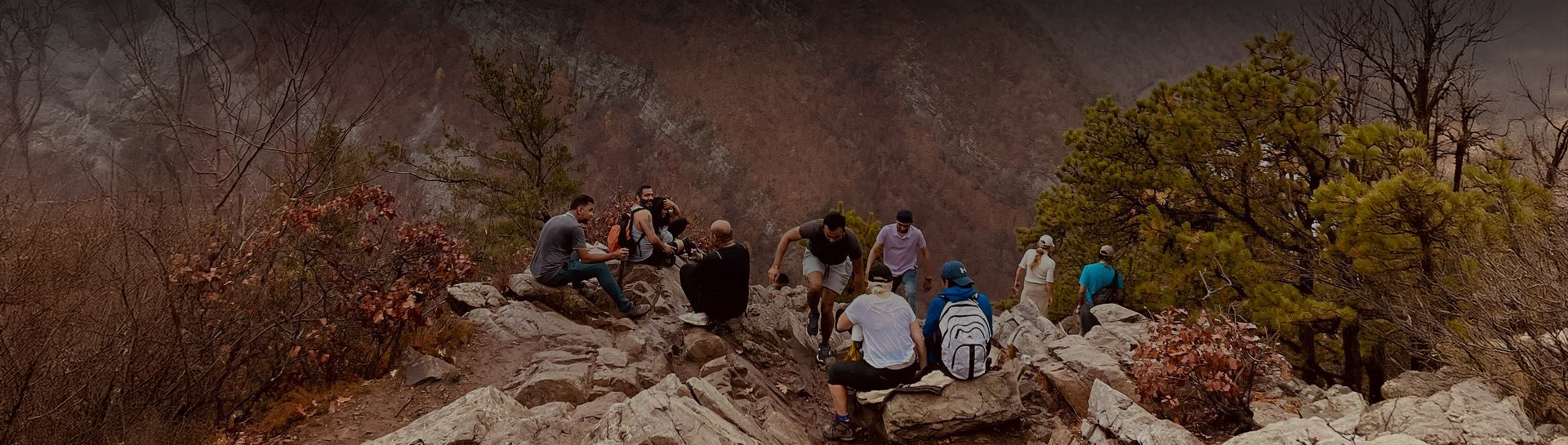 a group of people sitting on rocks